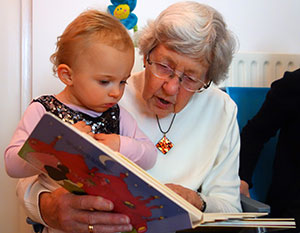 grandmother reading to toddler