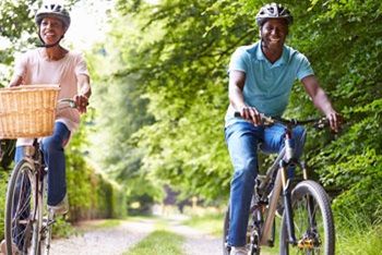 smiling woman and man riding bikes