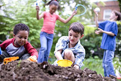 children playing in dirt pile