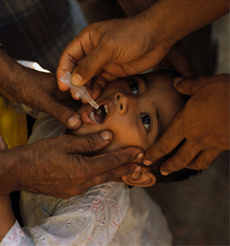 Boy being fed medicine