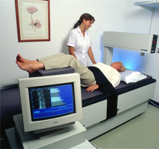 Radiology technician assists patient in MRI machine