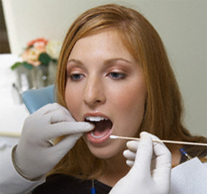 Woman getting teeth examined