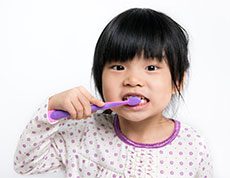 girl brushing her teeth