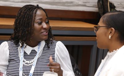 An APHA Kaiser Permanente Community Health Leadership Program fellow sitting at a table and chatting with a placement site supervisor
