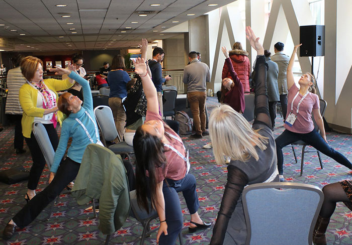 people doing yoga in convention center