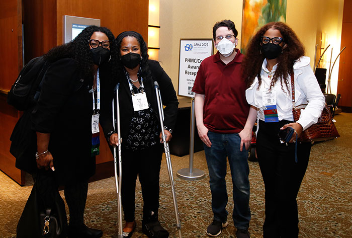 Four attendees at the Council on Affiliates reception pose for the camera.